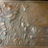 The left side of Summer Pond repoussé in copper